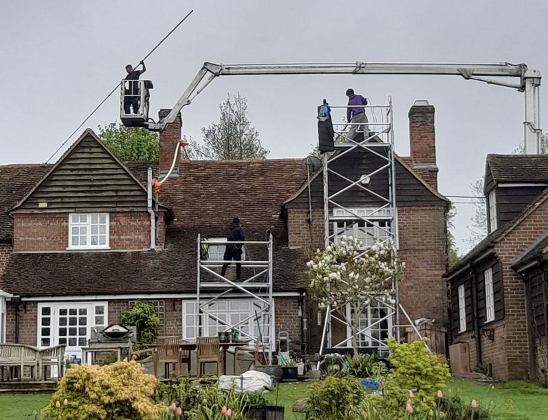 The Roof Moss Cleaners using cherry picker and scaffolding to clean roof safely and professionally in Crowthorne, Berkshire